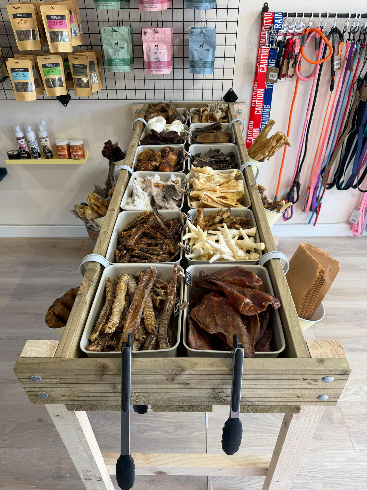 A display stand in a pet shop filled with raw treats
